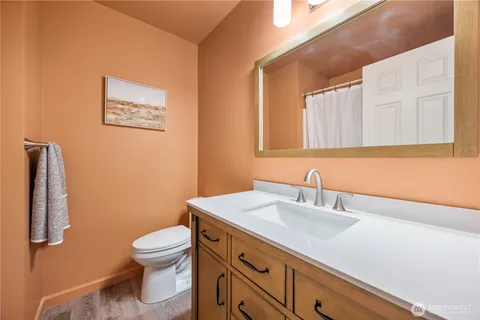 a bathroom with a sink mirror vanity and toilet