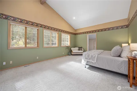 a spacious bedroom with a bed and a window