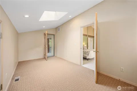 an empty room with a bathroom and a sink