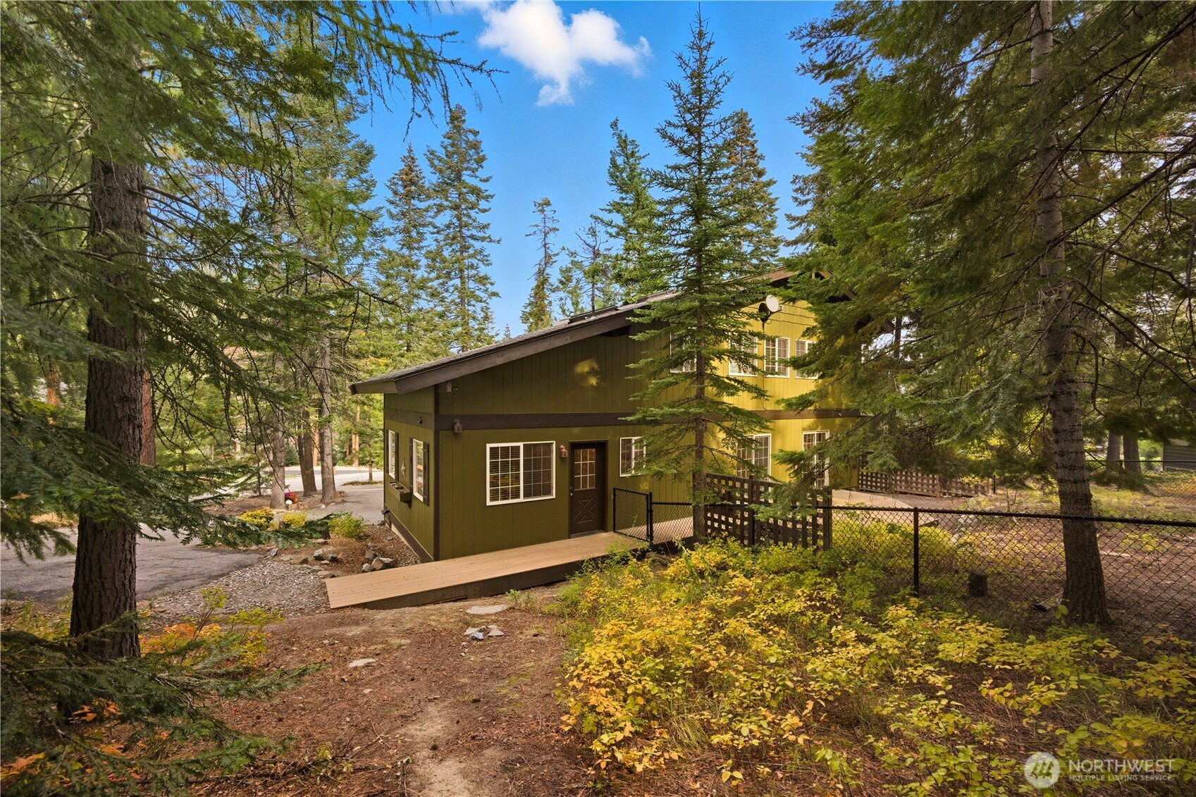 6545 Forest Ridge Drive Wenatchee, WA 98801 - Photo 36 of 40 a yellow house with trees in front of it