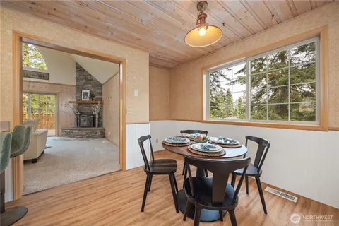 a view of a dining room with furniture window and wooden floor