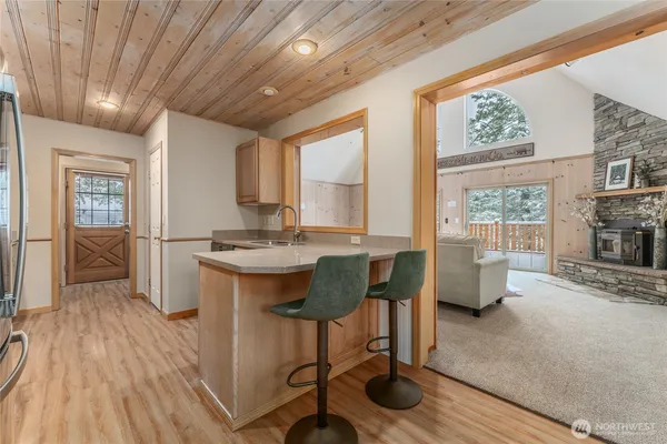a kitchen with cabinets wooden floor and stainless steel appliances