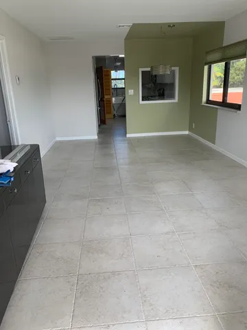 an empty room with large windows