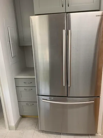 a kitchen with cabinets and chairs