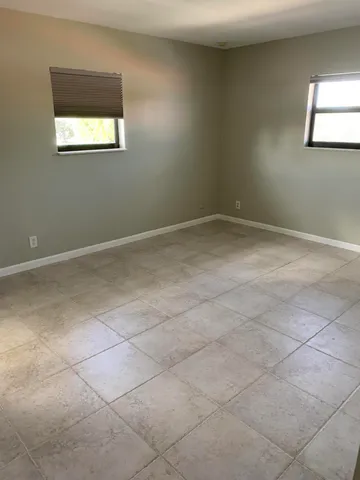 a white toilet sitting next to a white sink and vanity