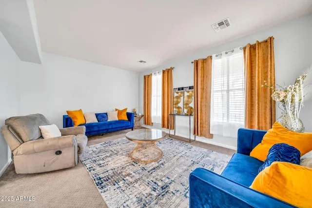 a kitchen with stainless steel appliances granite countertop a stove a sink dishwasher a refrigerator and a dining table with wooden cabinet