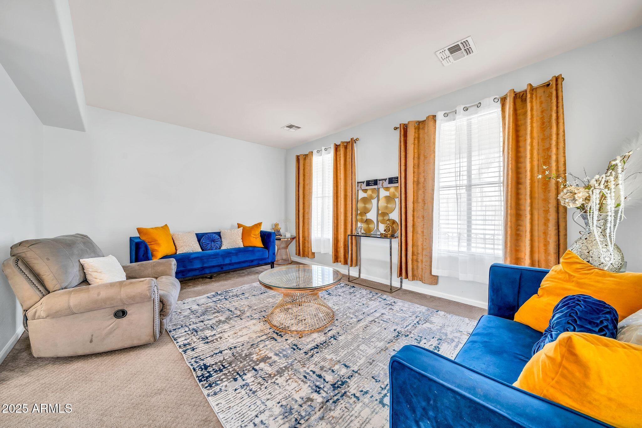 2292 South 155th Lane Goodyear, AZ 85338 - Photo 11 of 62 a living room with furniture and a large window