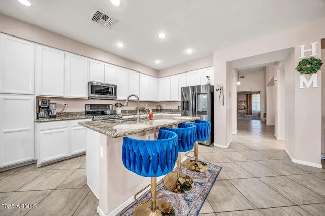 a kitchen with stainless steel appliances granite countertop a sink and cabinets