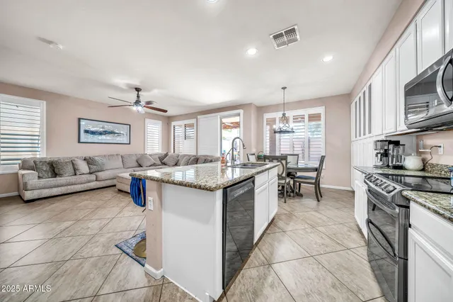 a bedroom with furniture and a flat screen tv