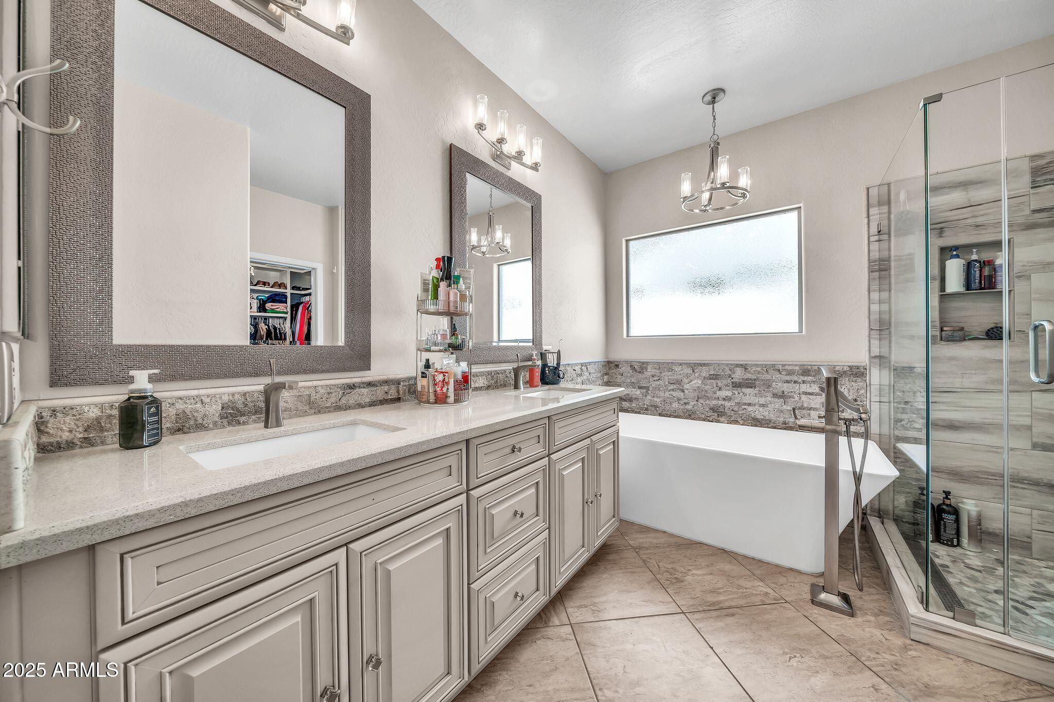 2292 South 155th Lane Goodyear, AZ 85338 - Photo 20 of 62 a bathroom with a granite countertop sink mirror and bathtub