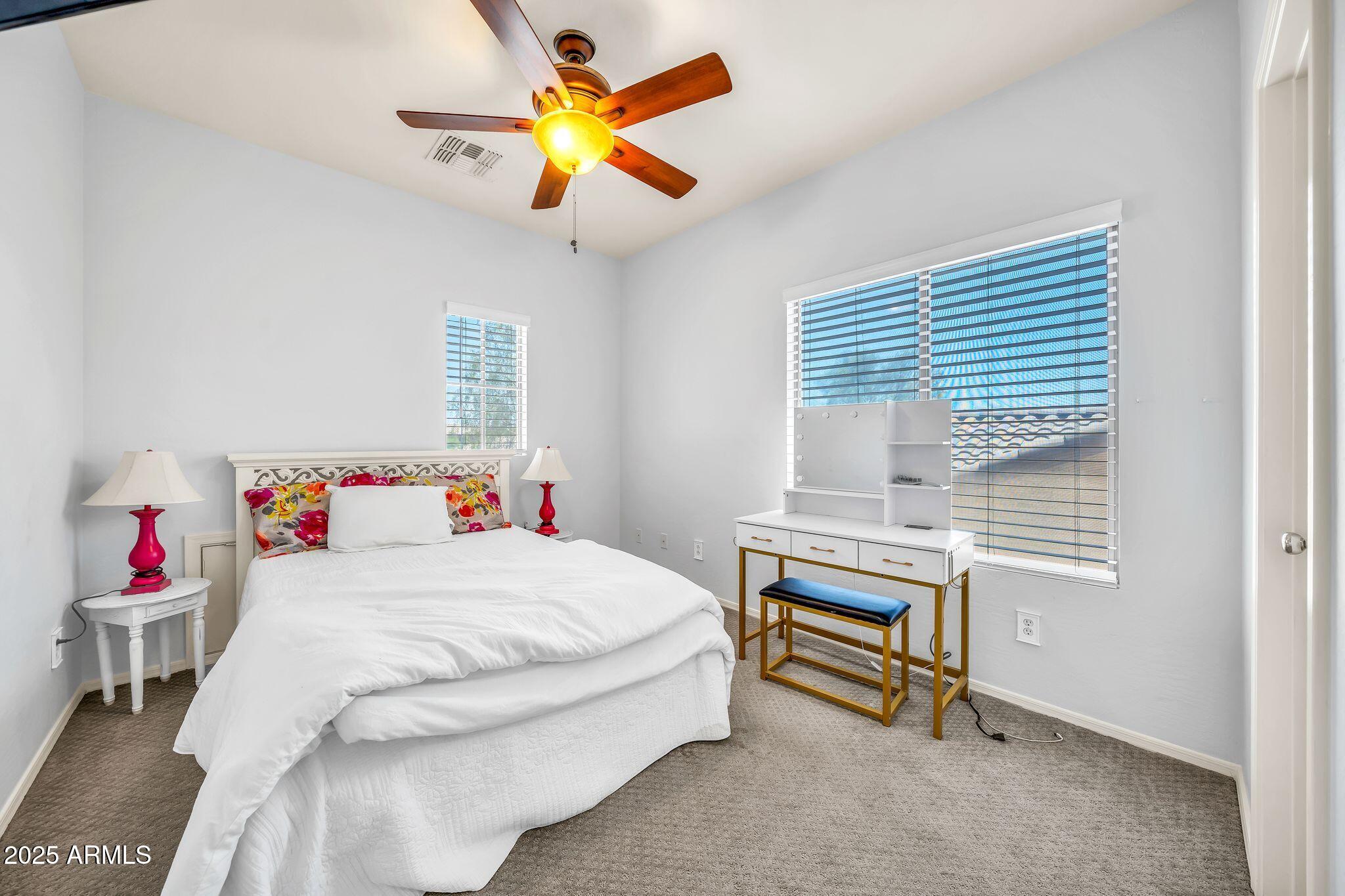 2292 South 155th Lane Goodyear, AZ 85338 - Photo 29 of 62 a bedroom that has a bed and a table in it
