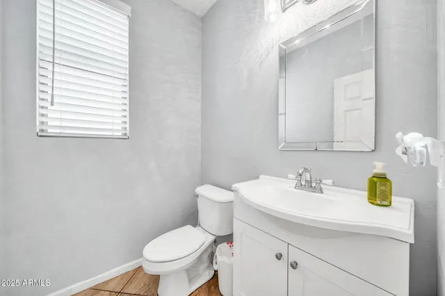 a bathroom with a sink a toilet and shower curtain