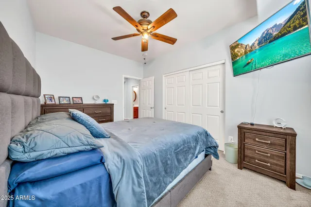 a view of swimming pool with lawn chairs and plants