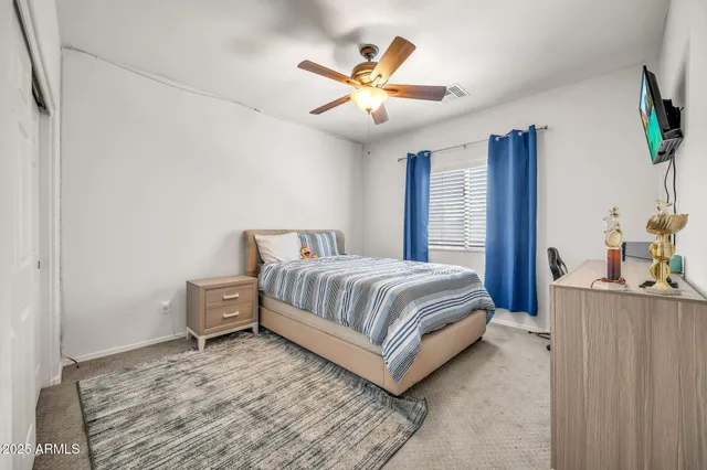 a view of a livingroom with furniture and a ceiling fan
