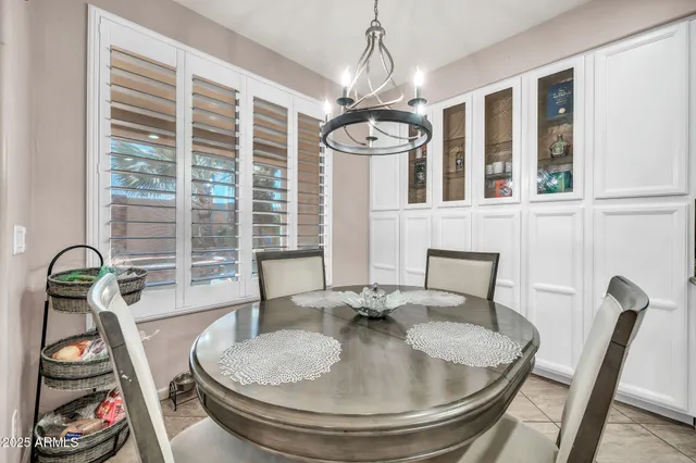 a view of a dining room with furniture and a chandelier