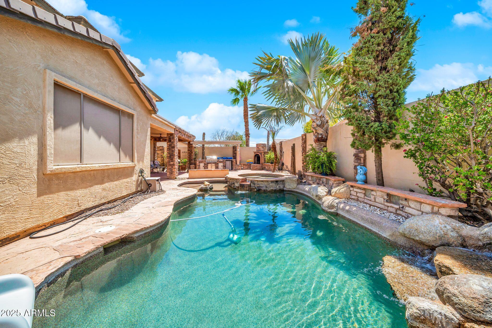 2292 South 155th Lane Goodyear, AZ 85338 - Photo 43 of 62 a view of swimming pool with lawn chairs and plants