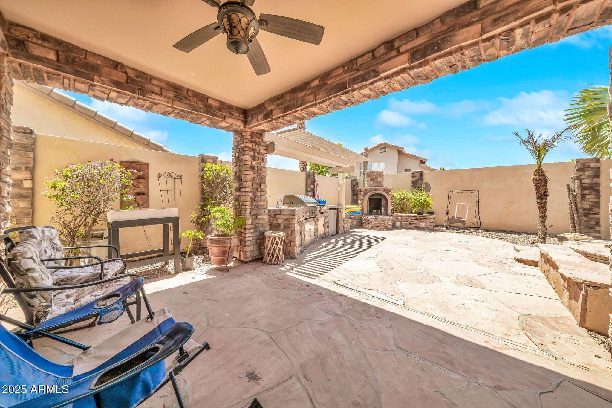 2292 South 155th Lane Goodyear, AZ 85338 - Photo 48 of 62 a view of a livingroom with furniture and a ceiling fan