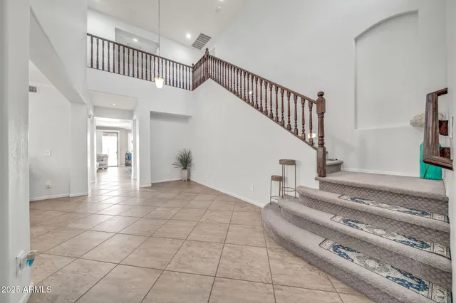 a bedroom with furniture and a large window