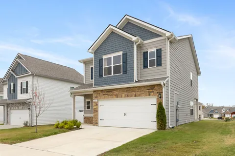 a view of a house with a yard and garage