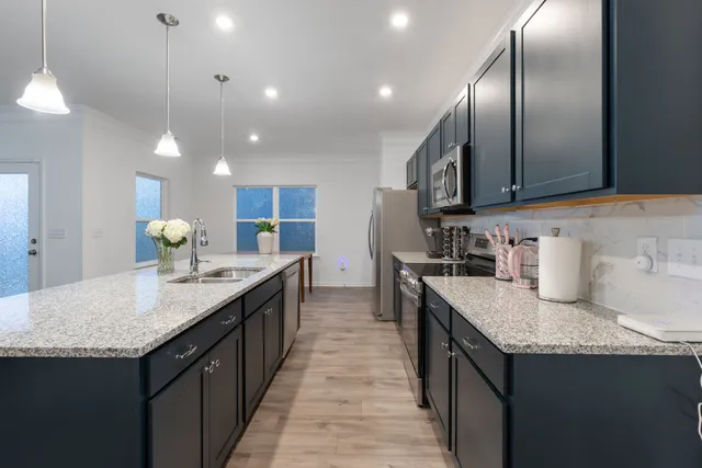 a kitchen with granite countertop counter top space a sink stainless steel appliances and cabinets