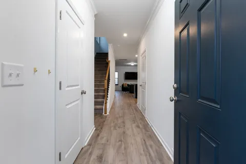 a view of hallway with wooden floor