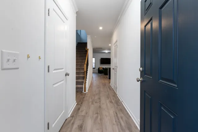 a view of hallway with wooden floor