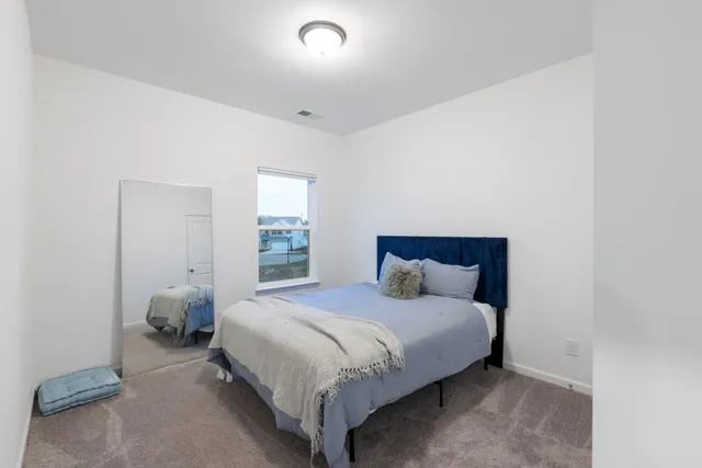 a bedroom with a bed and window