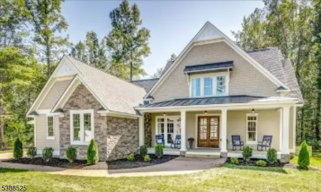 a view of a house with swimming pool and sitting area