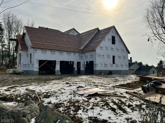 a view of a house with a wooden fence