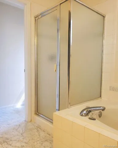 a bathroom with a tub and a shower