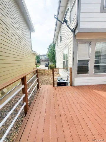 a view of a house with barbeque and wooden floor