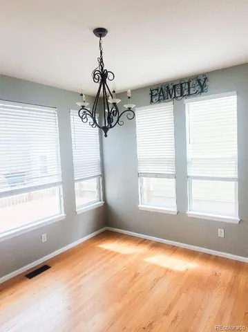 a view of a room with windows and chandelier