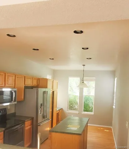 a kitchen with stainless steel appliances granite countertop a refrigerator and a sink