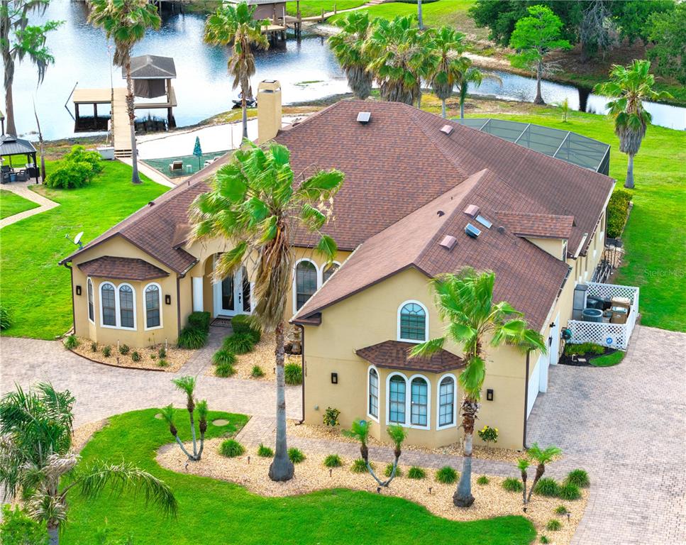 11325 Preston Cove Road Clermont, FL 34711 - Photo 1 of 58 an aerial view of a house with a garden and plants
