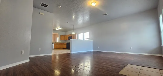 a view of a living room a kitchen and a sink