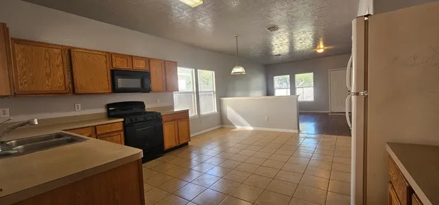 a view of a kitchen with microwave and cabinets