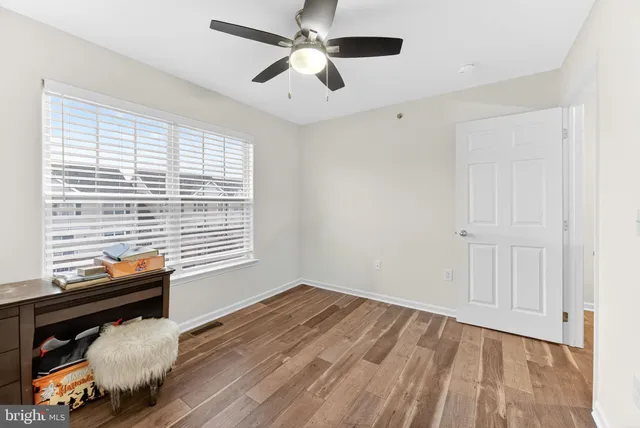 a room with a bed and a ceiling fan