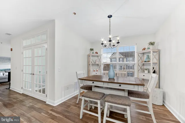a view of a room with wooden floor windows and entryway