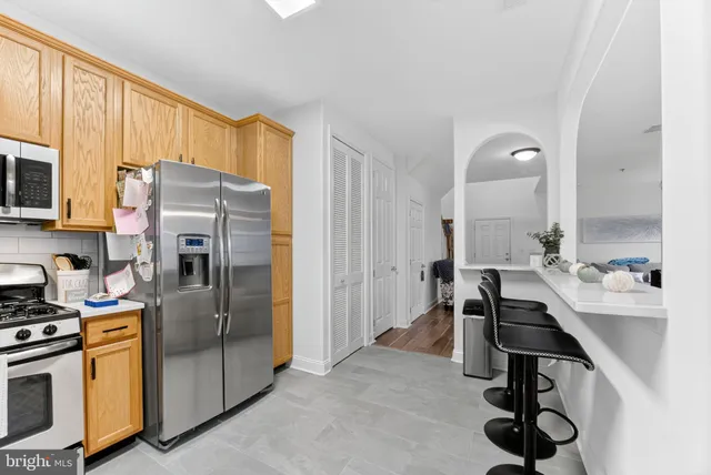 a kitchen with a refrigerator and a sink