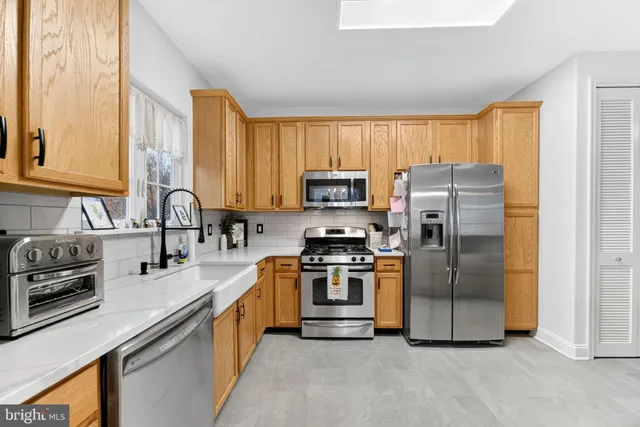 a kitchen with a refrigerator sink and stainless steel appliances