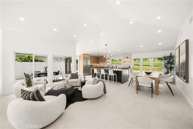a kitchen with a table chairs and a living room