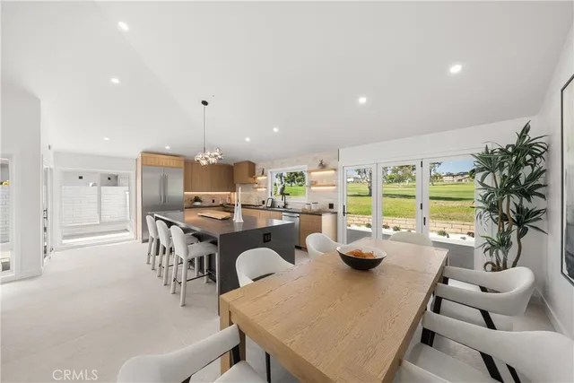a kitchen with kitchen island granite countertop a sink and a stove top oven