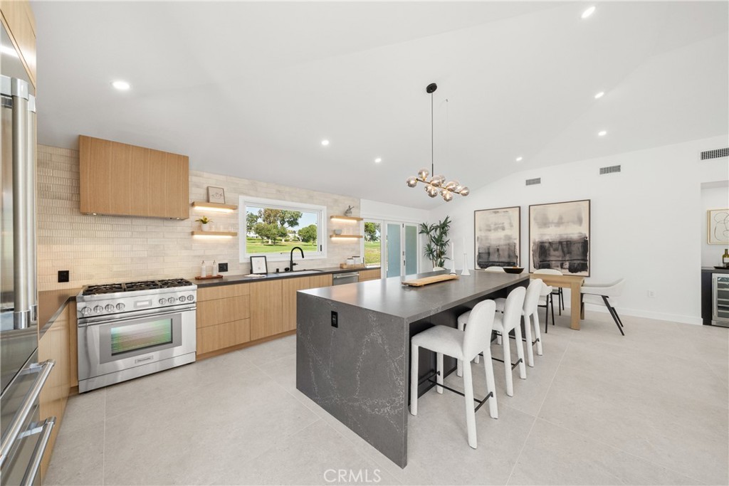 19741 Quiet Bay Lane Huntington Beach, CA 92648 - Photo 17 of 33 a kitchen with kitchen island granite countertop a sink and a stove top oven