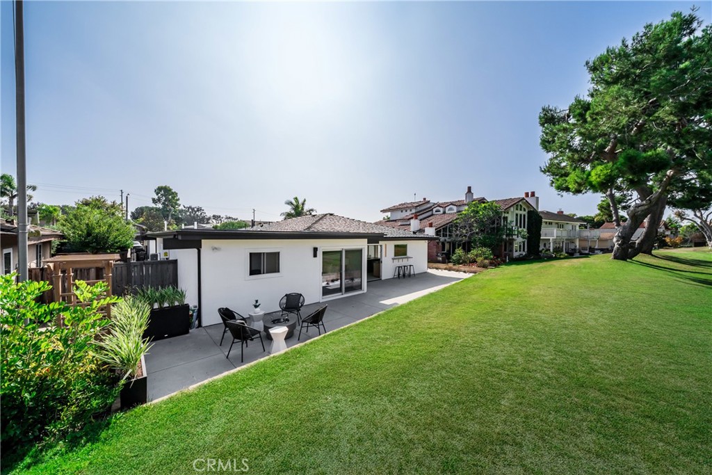 19741 Quiet Bay Lane Huntington Beach, CA 92648 - Photo 21 of 33 a view of a house with backyard sitting area and garden