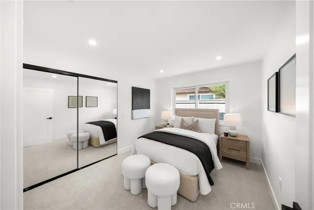 a patio with a table and chairs and potted plants