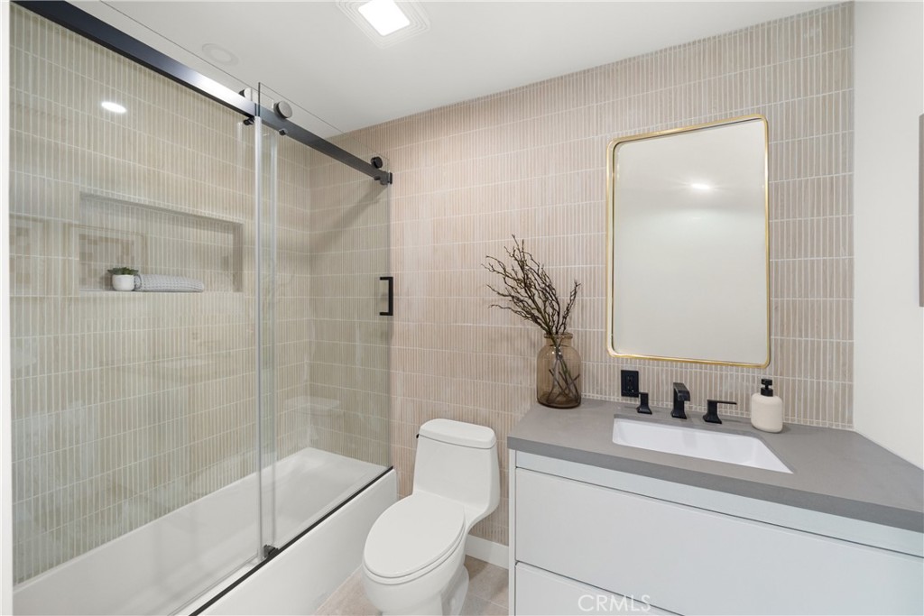 19741 Quiet Bay Lane Huntington Beach, CA 92648 - Photo 29 of 33 a bathroom with a sink a toilet and shower