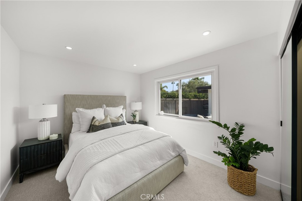 19741 Quiet Bay Lane Huntington Beach, CA 92648 - Photo 30 of 33 a bedroom with a bed and a potted plant