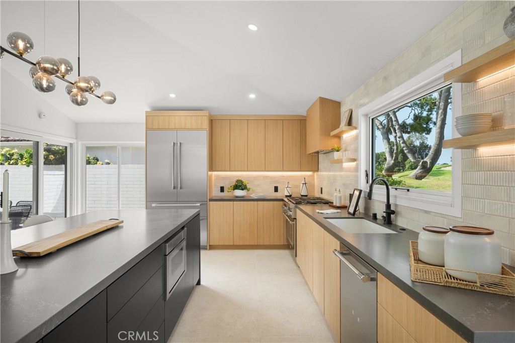 19741 Quiet Bay Lane Huntington Beach, CA 92648 - Photo 4 of 33 a kitchen with a sink stove and cabinets