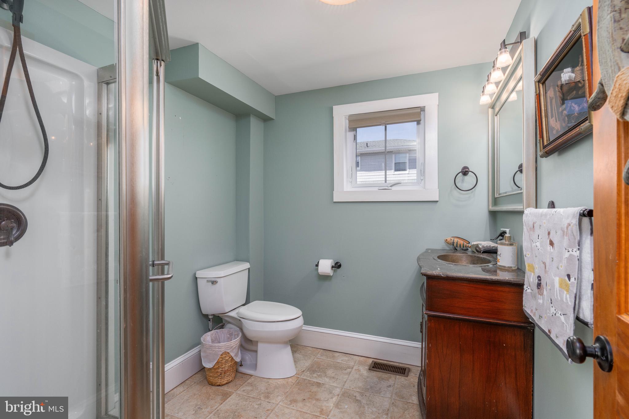 98 Delaware Avenue Fortescue, NJ 08321 - Photo 14 of 51 a white toilet sitting next to a bathroom sink