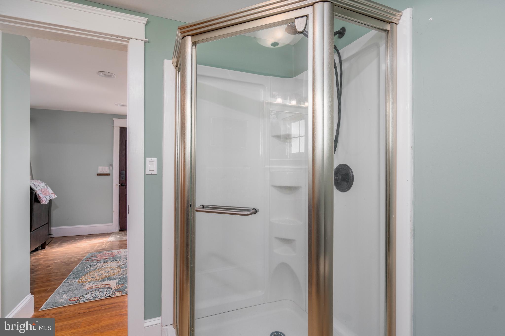 98 Delaware Avenue Fortescue, NJ 08321 - Photo 15 of 51 a bathroom with a glass shower door and a mirror